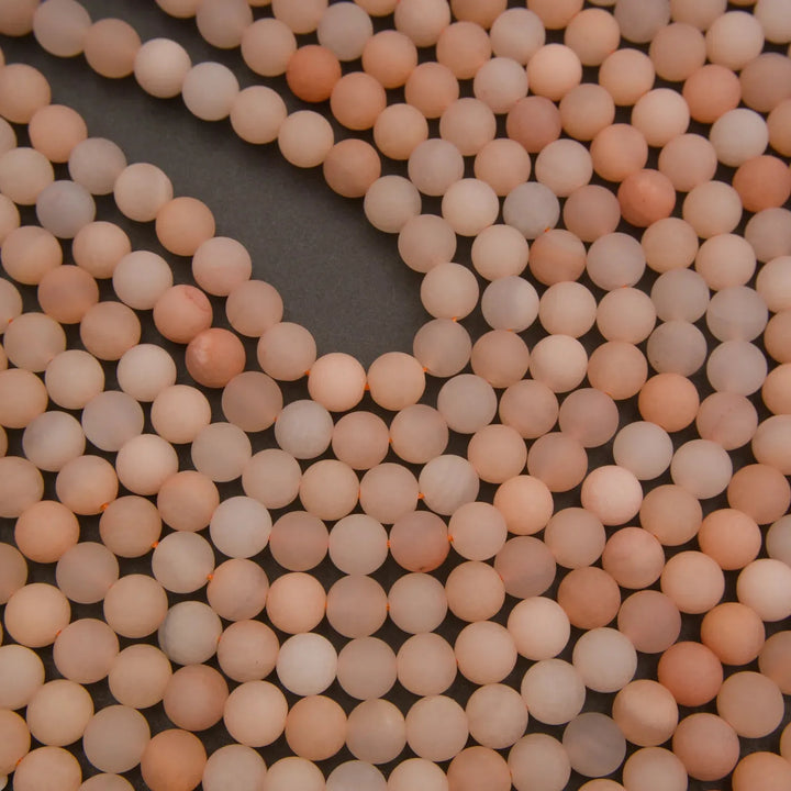 Close-up of pinkish-beige beads on a dark background