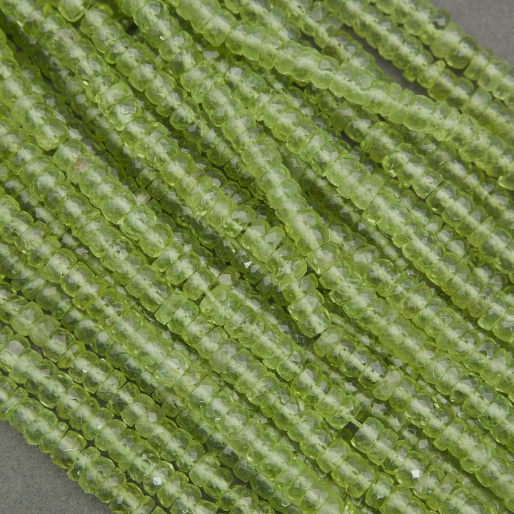 Natural peridot beads with vivid green color and translucent clarity, faceted rondelles