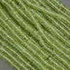 Natural peridot beads with vivid green color and translucent clarity, faceted rondelles