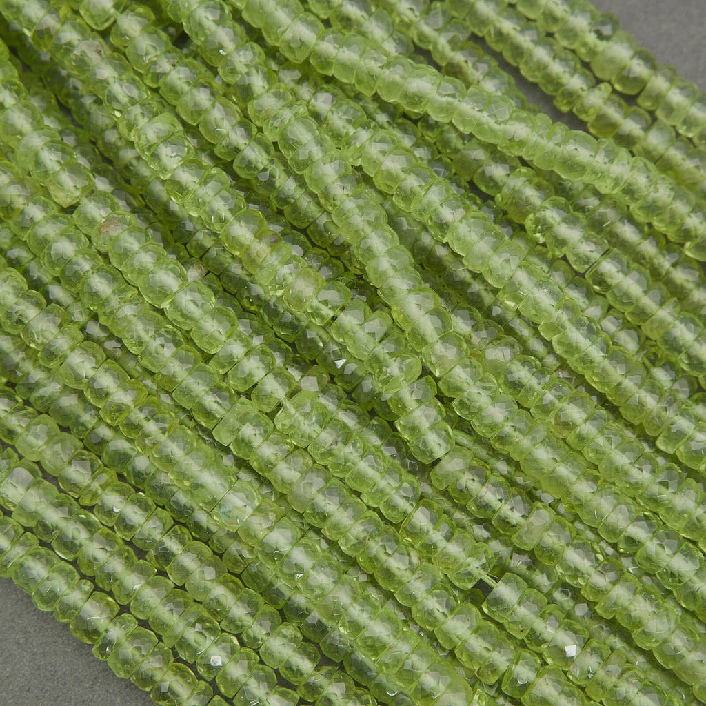 Natural peridot beads with vivid green color and translucent clarity, faceted rondelles