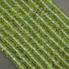 Peridot beads close-up showing natural texture, inclusions, and sparkle