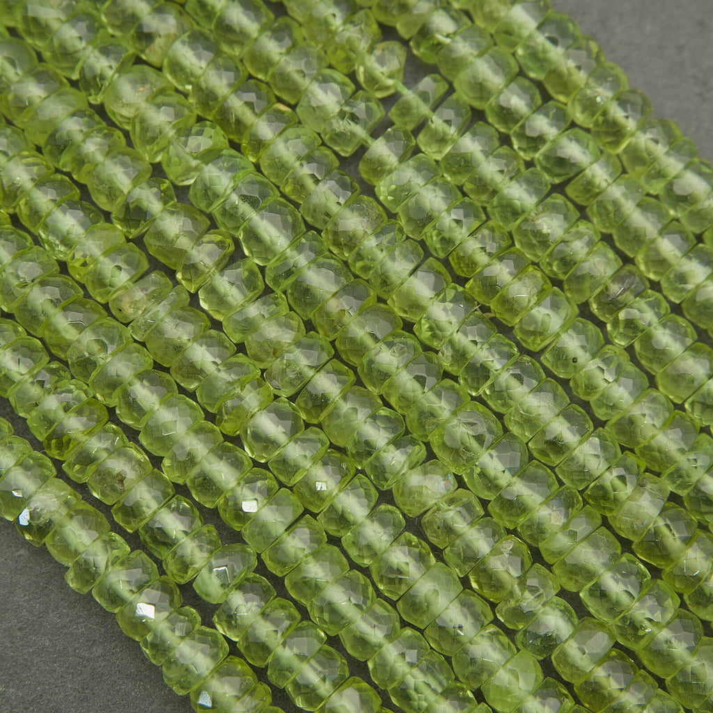 Peridot beads close-up showing natural texture, inclusions, and sparkle