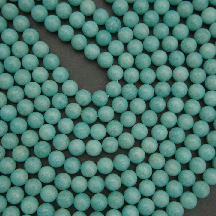 Close-up of turquoise beads on a dark background
