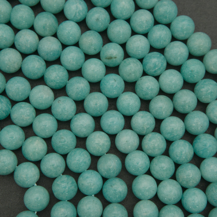 Close-up of teal beads on a dark background