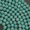 Close-up of teal beads on a dark background