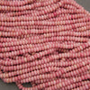 Strands of polished pink gemstone rondelle beads
