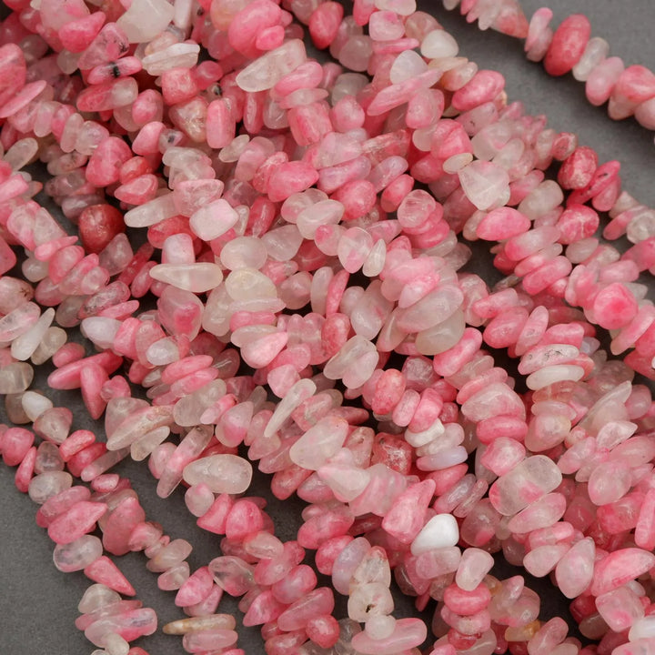 Close-up of pink and white pebbles on a dark surface