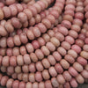 Pink rondelle rhodonite beads.