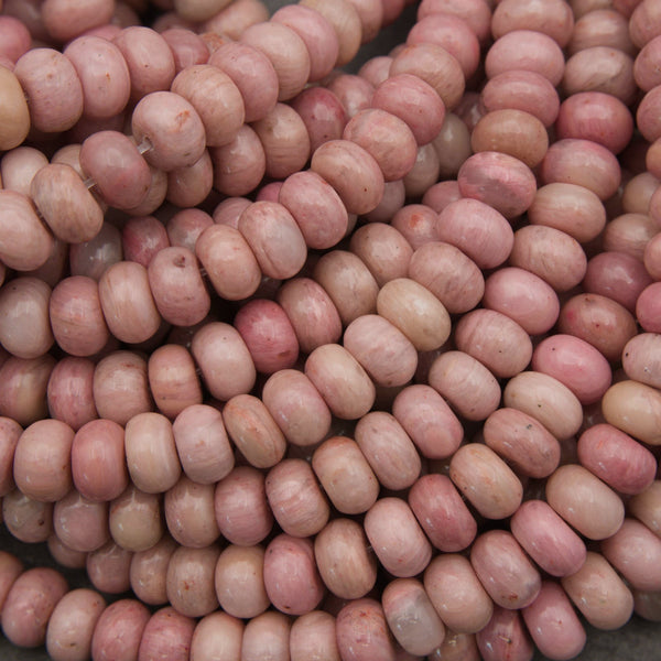 Pink rondelle rhodonite beads.