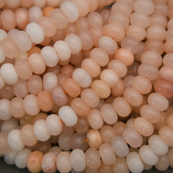 Polished Peach Aventurine rondelle gemstone beads on strands.