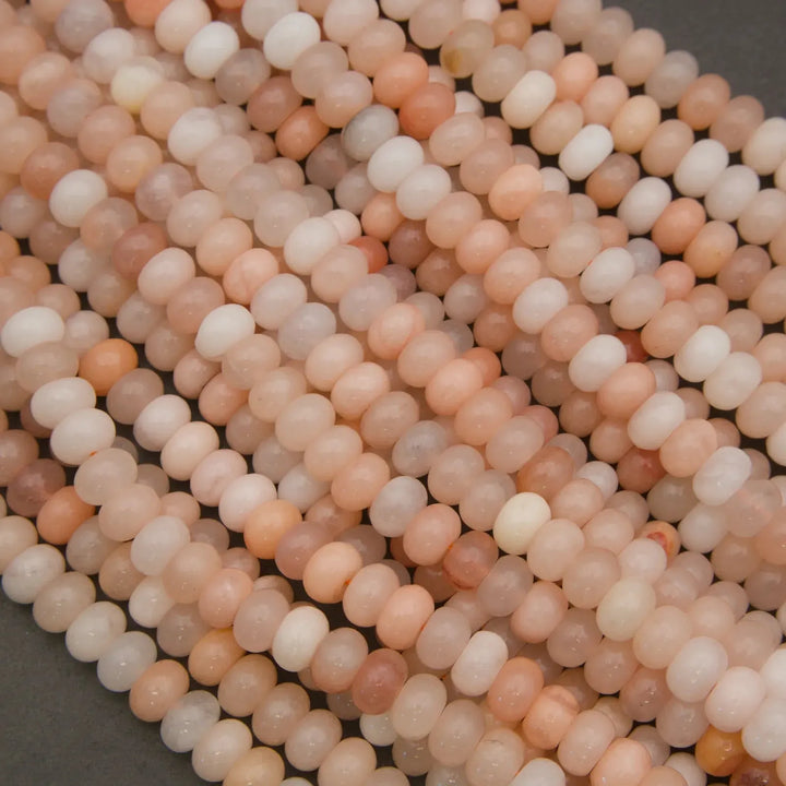 Natural Peach Aventurine rondelle beads with soft peach and cream coloration.