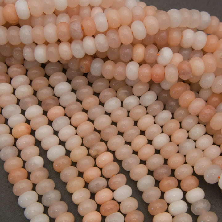Peach Aventurine rondelle beads featuring warm pastel tones and a glossy finish.