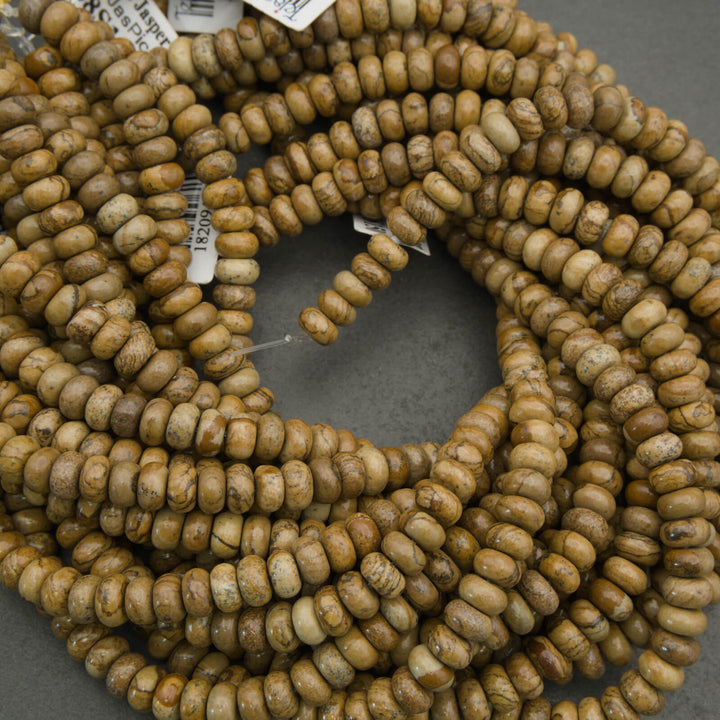 Close-up of a string of brown beads on a gray surface