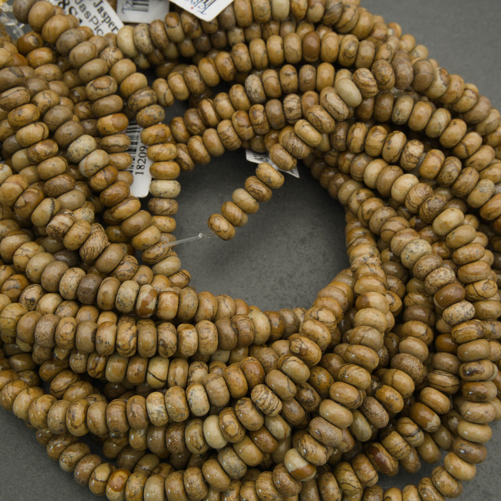 Close-up of a string of brown beads on a gray surface