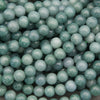 Natural Guatemalan jade round beads featuring soft mint green, seafoam, and teal tones with a glossy polished finish.