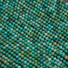 Small turquoise round beads in mixed shades of blue and green with rustic brown inclusions and a smooth finish.