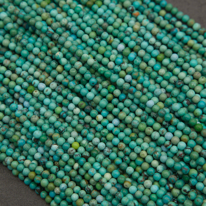 Turquoise gemstone beads with unique natural matrix patterns and varied blue-green coloration.