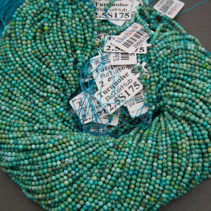 Natural turquoise round beads in shades of aqua blue, seafoam green, and teal with earthy brown matrix patterns.