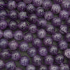 Close-up of purple beads on a dark background.