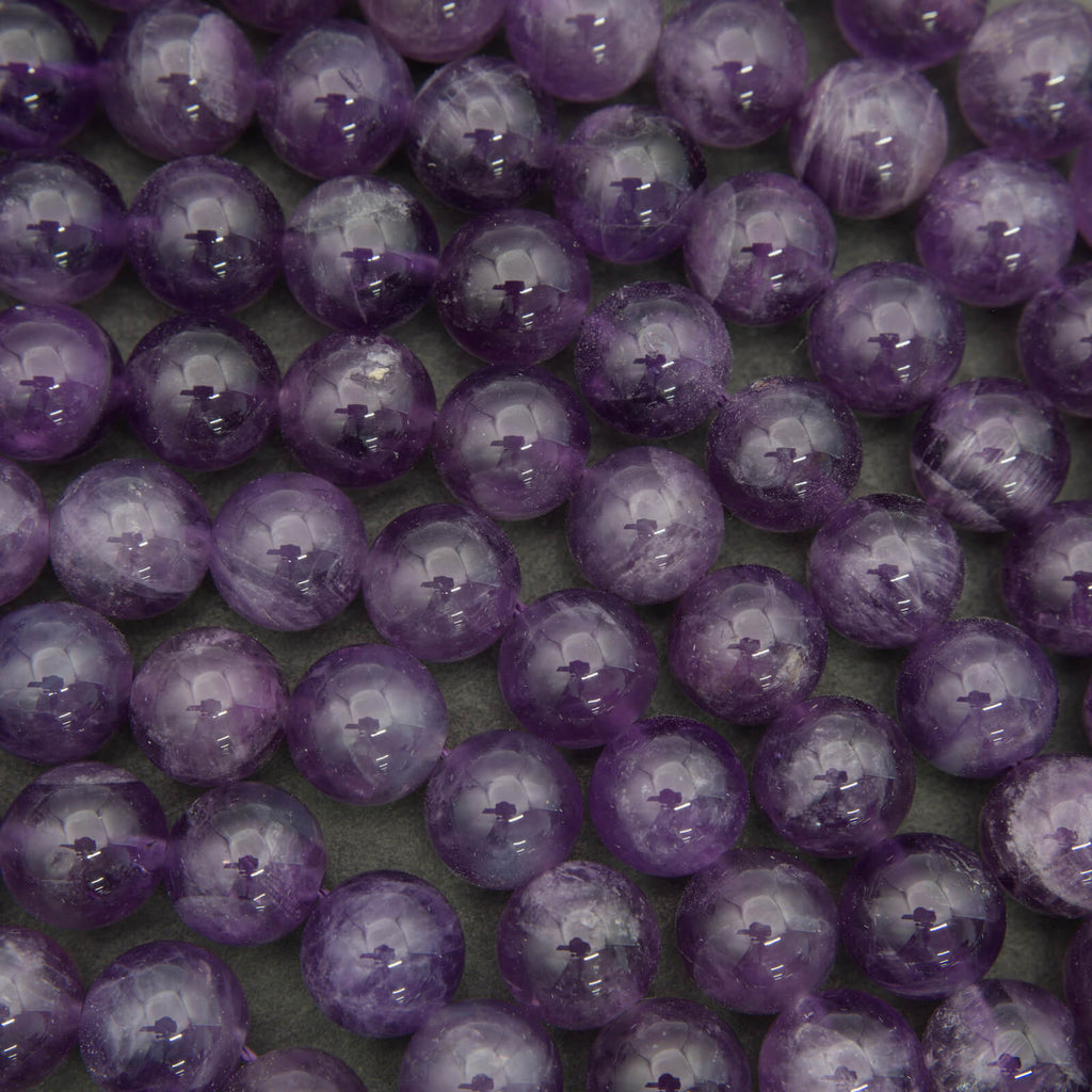Close-up of purple beads on a dark background.