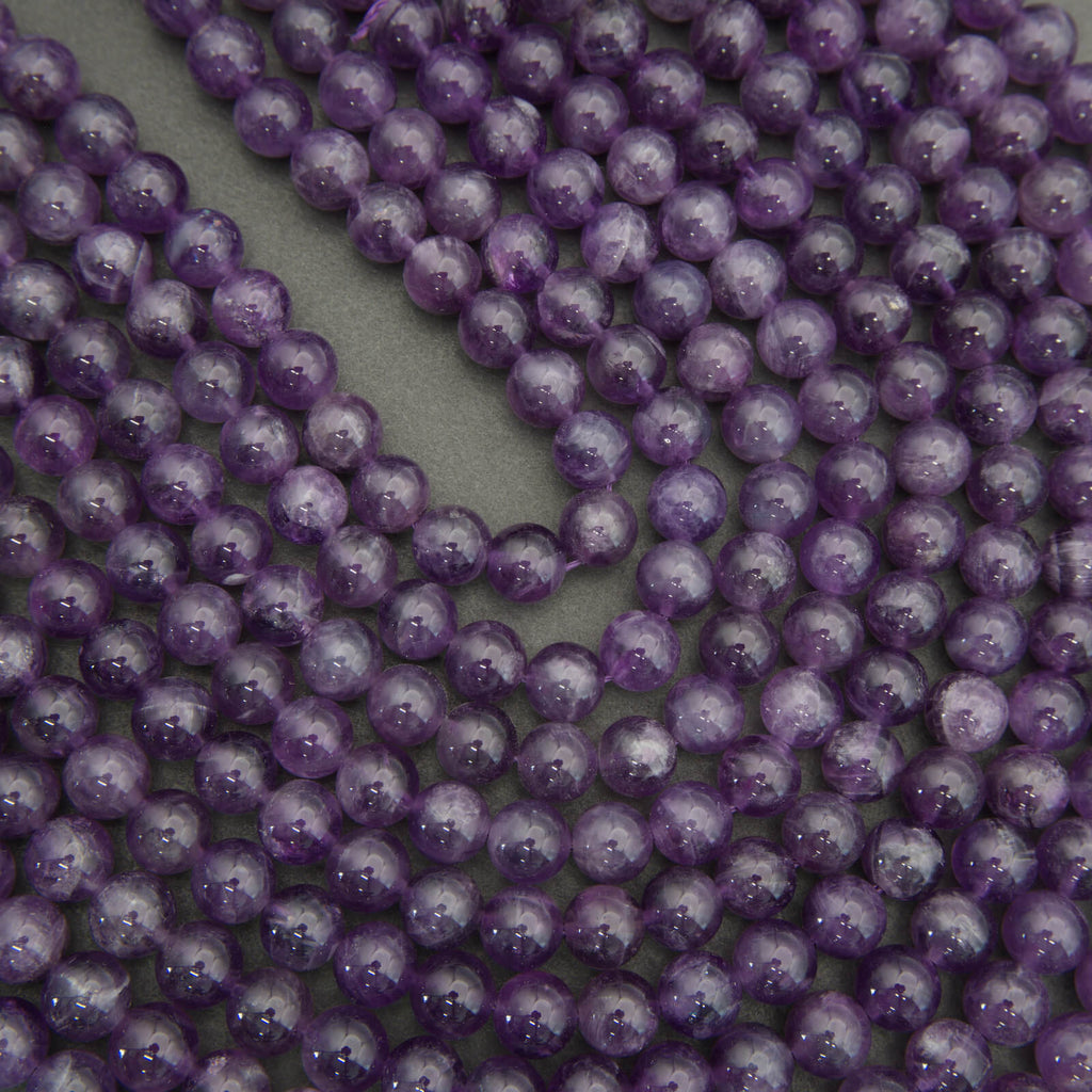 Close-up of purple beads on a gray background