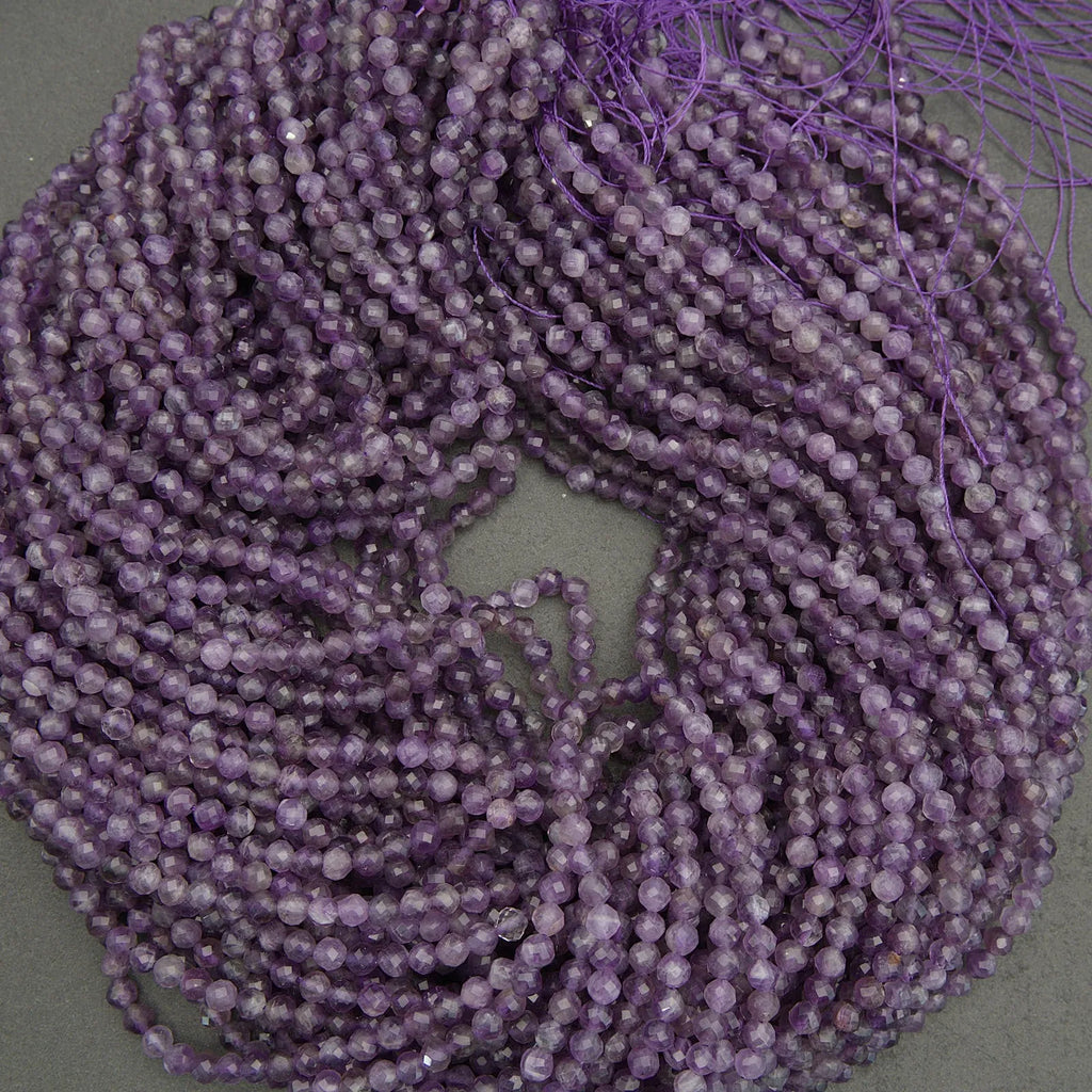 Purple beaded string on a gray background