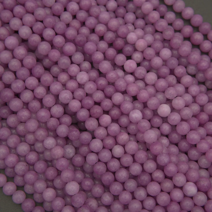 Close-up of purple round beads on a dark background