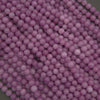 Close-up of purple round beads on a dark background
