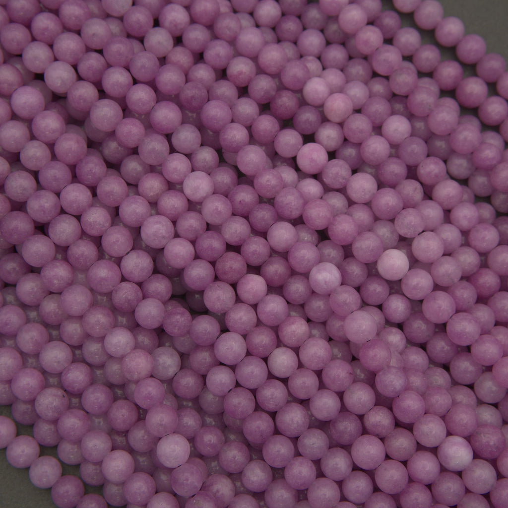 Close-up of purple round beads on a dark background