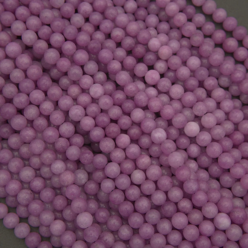 Close-up of purple round beads on a dark background