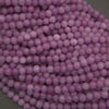 Close-up of purple beads on a green background