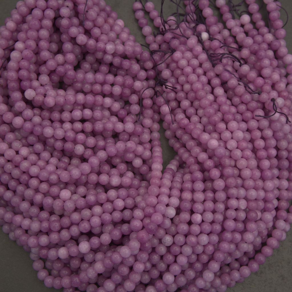 Purple beads on a string with a neutral background