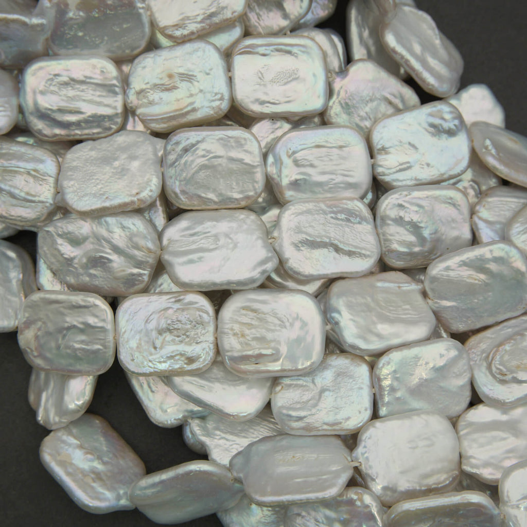 Close-up of light gray pebbles on a dark background