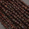 Close-up of dark red peppercorns on a gray background