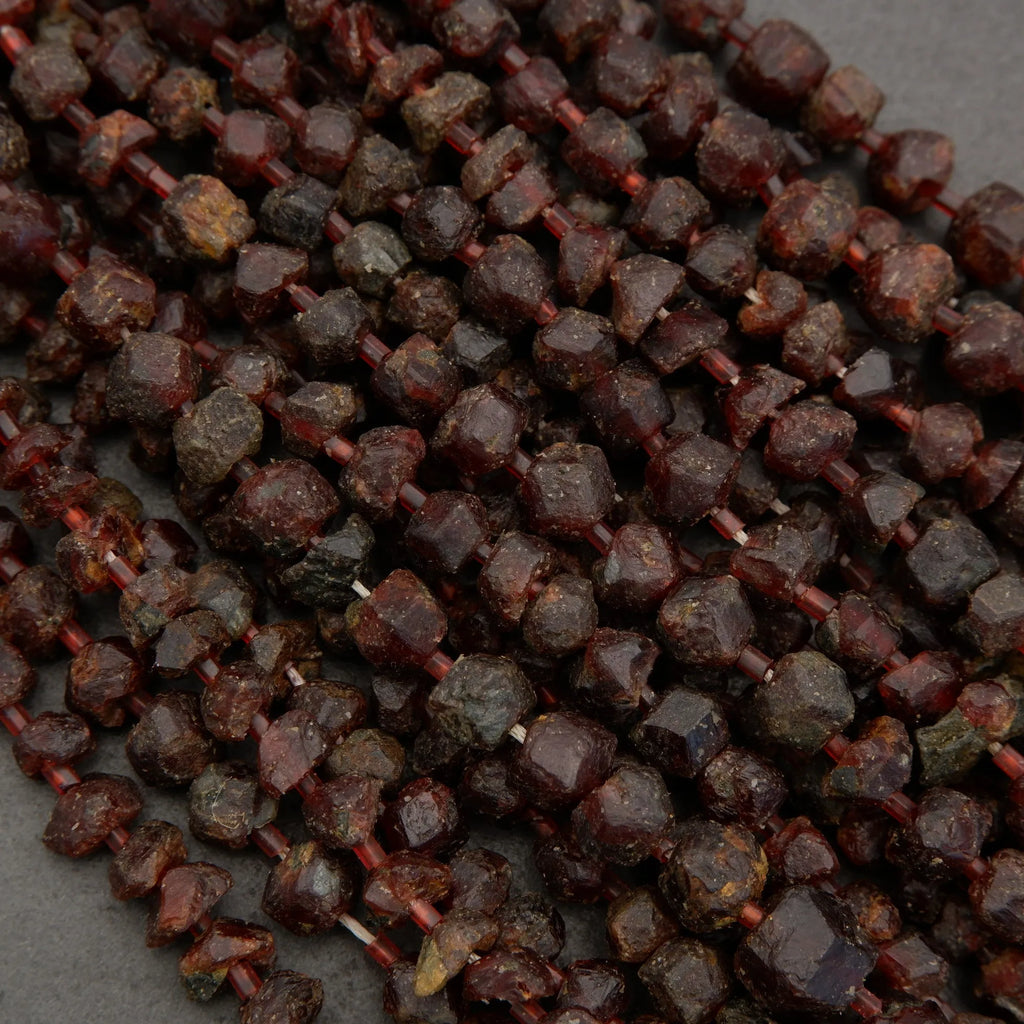 Close-up of dark red peppercorns on a gray background