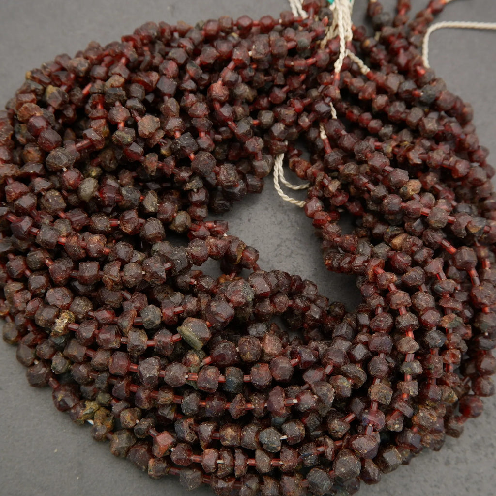 String of dark red beads on a gray background