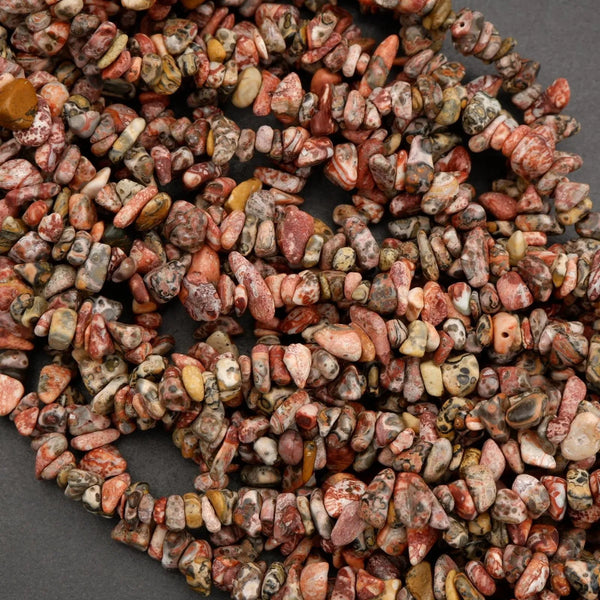 Close-up of a pile of multicolored stone beads on a dark background