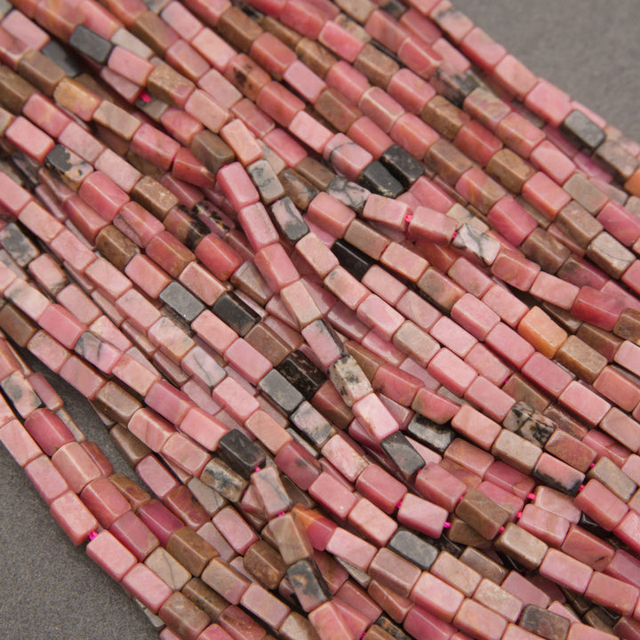 Rhodonite rectangular beads featuring soft pink, dusty rose, and black manganese oxide patterns.