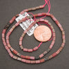 Rhodonite gemstone beads featuring smooth rectangular shapes and natural pink and black coloration.