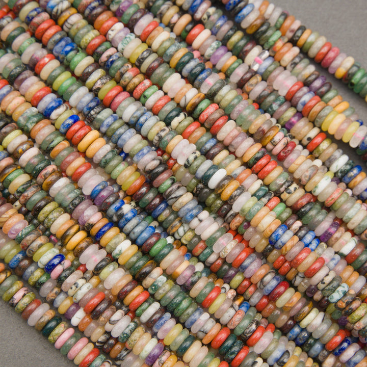 Strands of mixed gemstone rondelle beads in green, blue, red, pink, and yellow tones