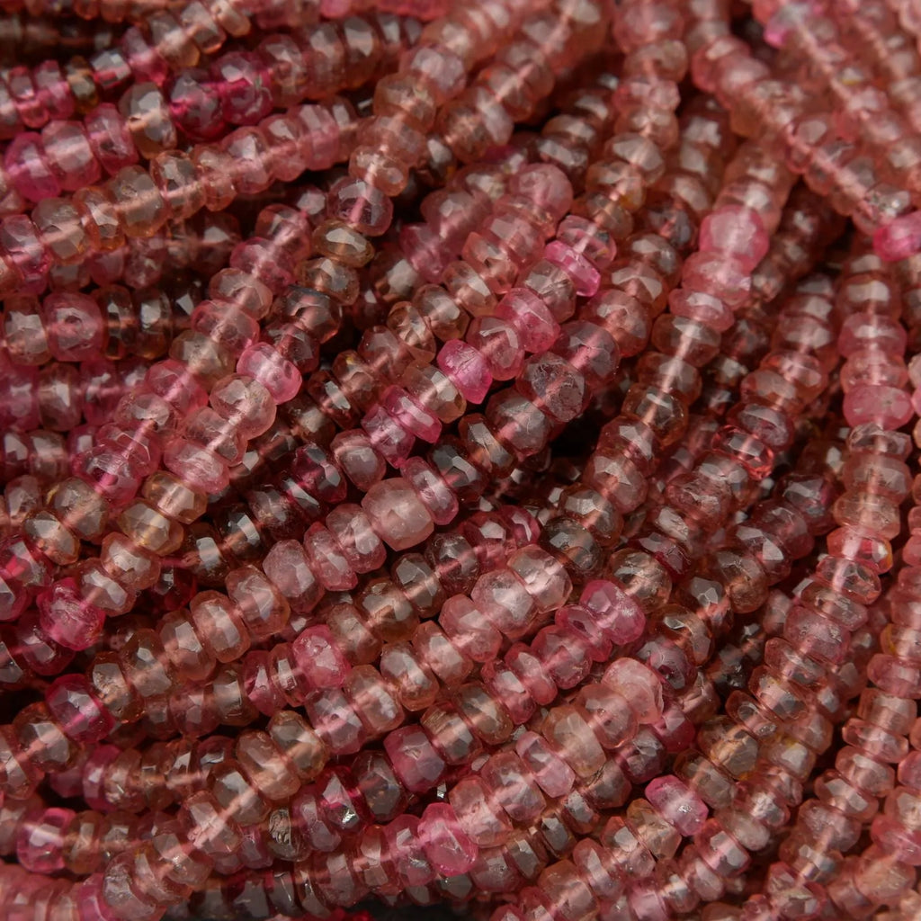 Close-up of pink and red stone beads on a string