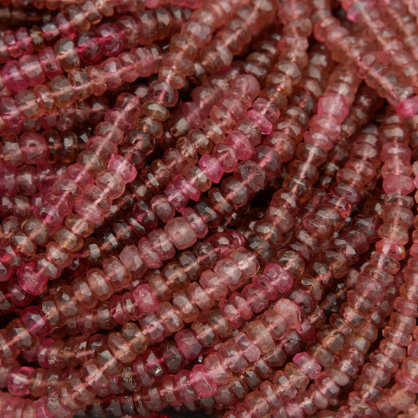 Close-up of pink and red stone beads on a string