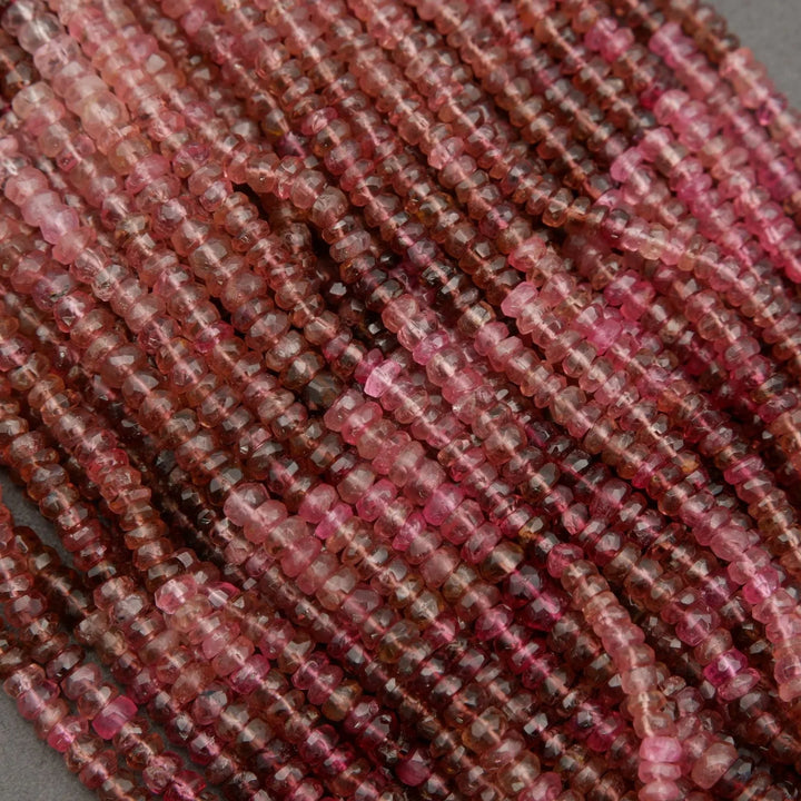 Close-up of red and brown stone beads on a gray background