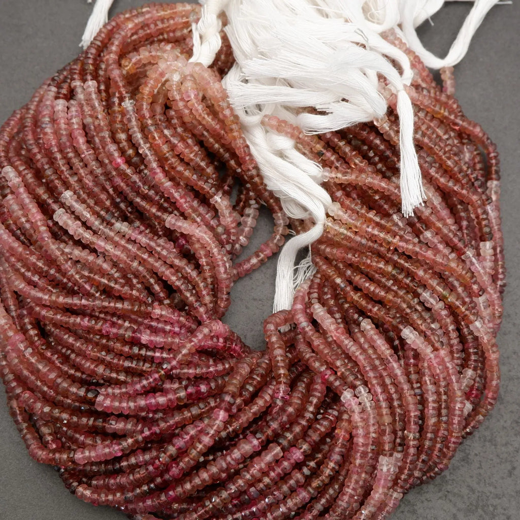 Strand of red beads with white string on a gray background