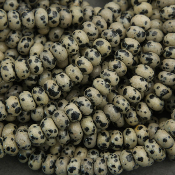 Close-up of beige beads with black spots on a gray background