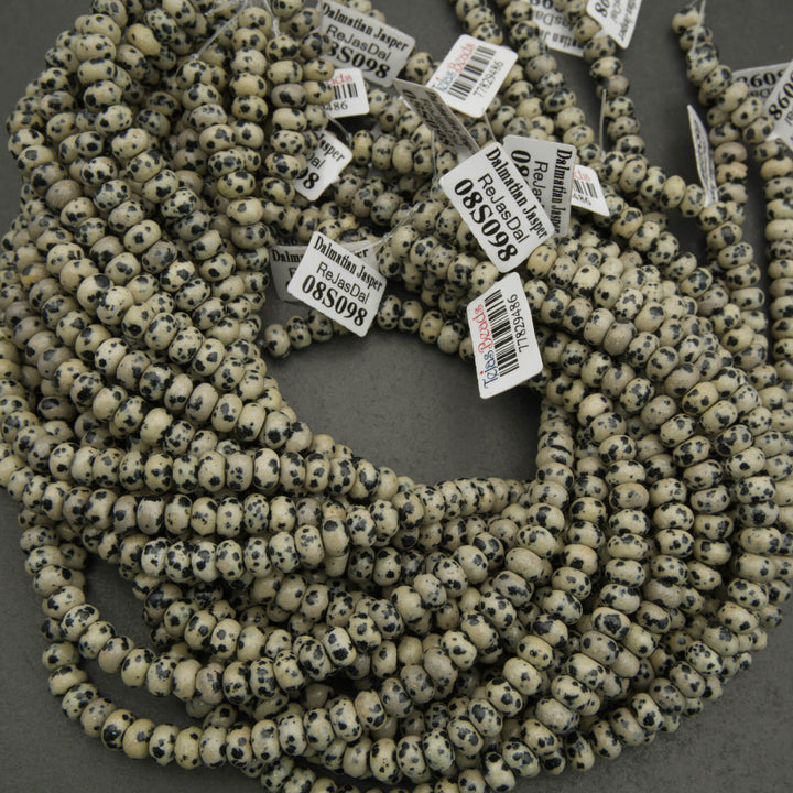 String of beads with price tags on a dark surface