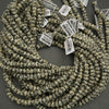 String of beads with price tags on a dark surface