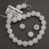 Rose Quartz bracelet on a dark gray background with a label.