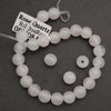 Rose Quartz bracelet on a dark gray background with a label.