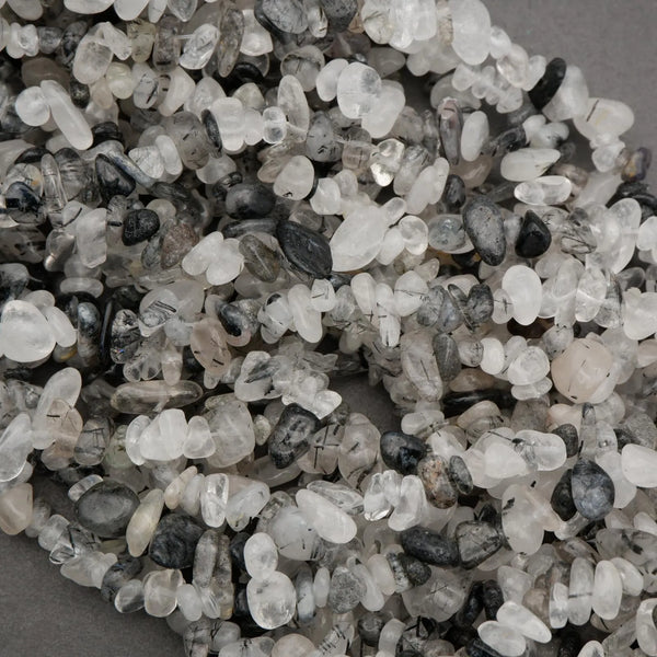 Close-up of small pebbles in various colors on a gray background